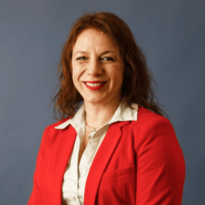 Woman manager in red, smiling.