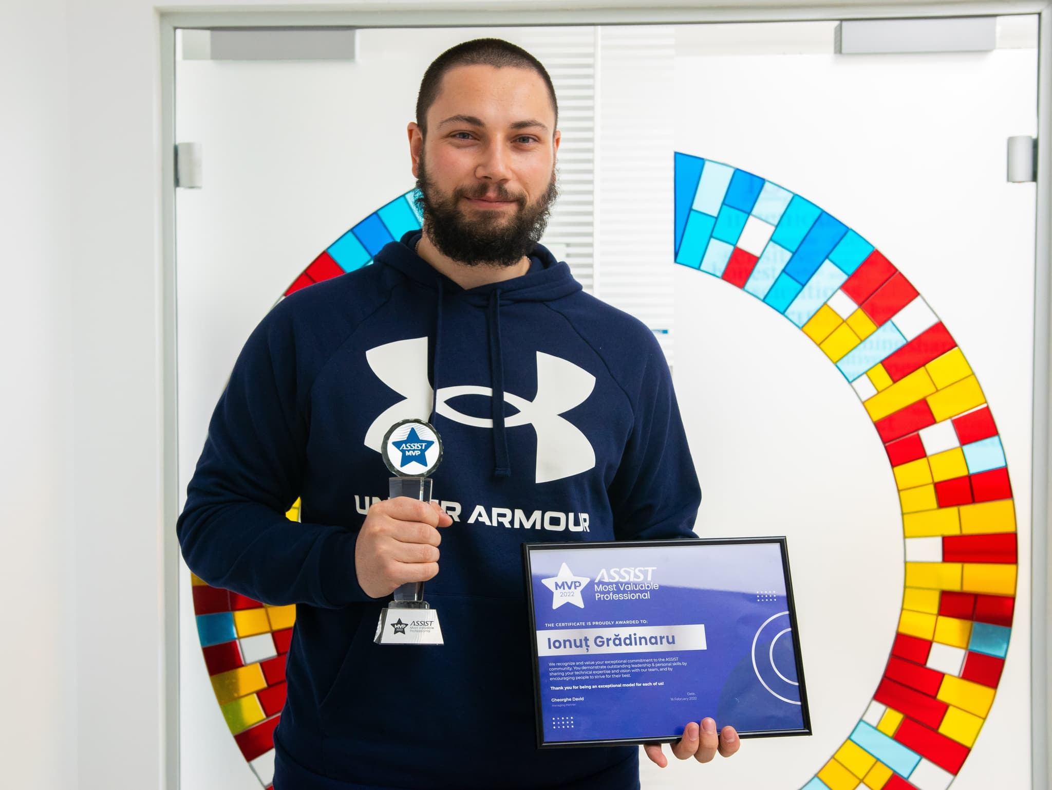 Ionut Holding the MVP award in ASSIST Software